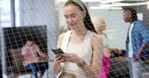 Young Professional Woman Using Smartphone in Modern Office Lounge with Glass Grid Overlay