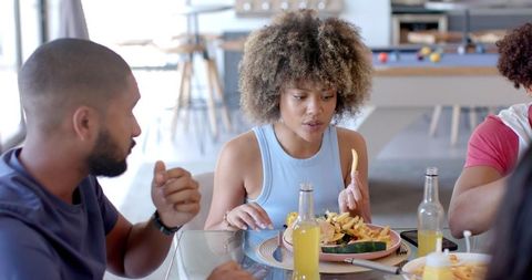 Relaxed Lunch Gathering with Friends Enjoying Food Indoors