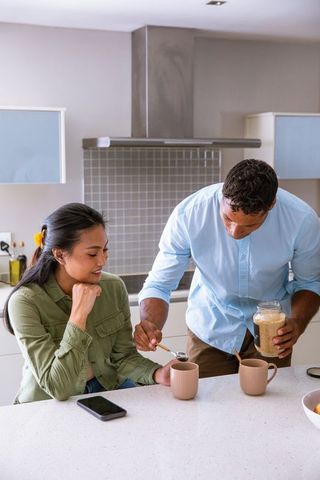 Couple Preparing Cozy Beverage in Contemporary Kitchen Setting