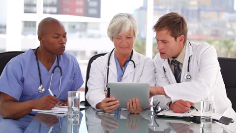 Medical Professionals Collaborating with Tablet Technology