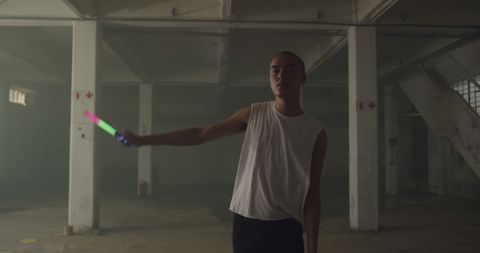 Trendy Man With Glow Stick in Industrial Warehouse Setting - Download Free Stock Images Pikwizard.com