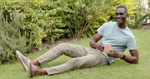 Man Relaxing in Garden with Coffee Mug and Wristwatch