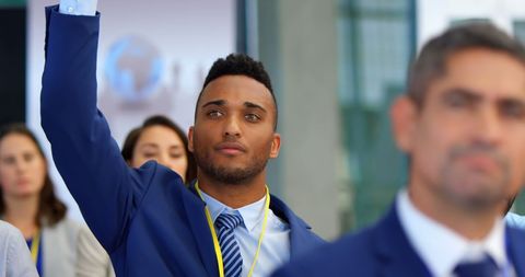 Confident Businessman Engaging in Seminar by Raising Hand - Download Free Stock Images Pikwizard.com