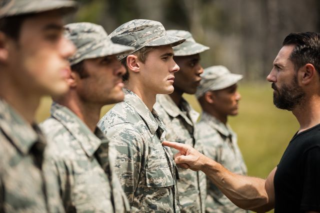 Trainer giving training to military soldier at boot camp