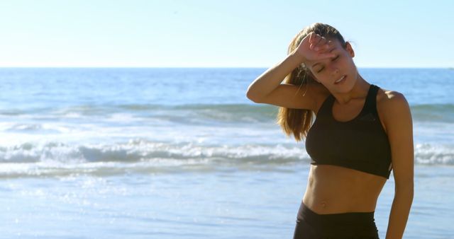 Tired fit woman standing in the beach 4k - Download Free Stock Photos Pikwizard.com