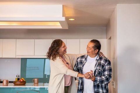 Senior Couple Share Romantic Dance in Cozy Kitchen