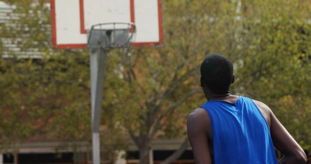 Man Aiming for Basketball Hoop Outdoors - Download Free Stock Images Pikwizard.com