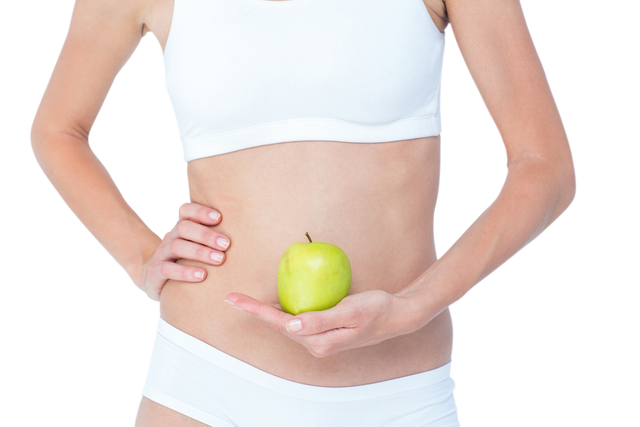 Healthy Woman Holding Green Apple in Front of Abs on Transparent Background - Download Free Stock Videos Pikwizard.com