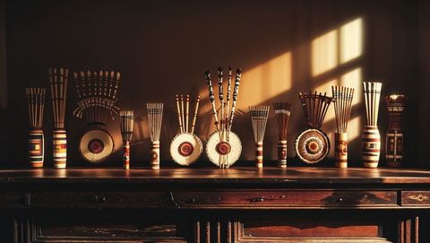 Bohemian sideboard with ethnic vases and shields in warm sunlight