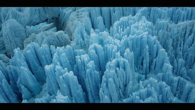 Crystal blue ice spires in polar canyon landscape