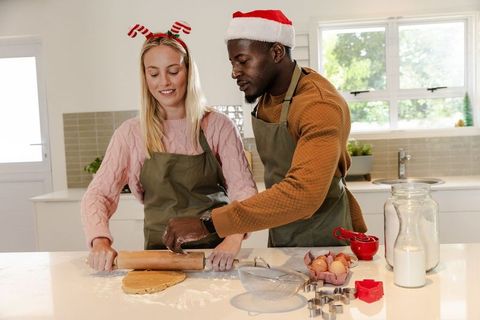 Diverse Couple Baking Holiday Cookies in Cozy Home Kitchen