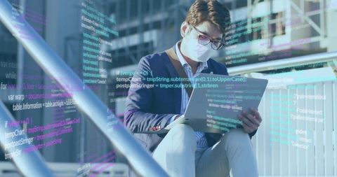 Professional Man Coding On Laptop In Modern Urban Environment