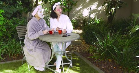 Mother and daughter bonding in backyard self-care ritual