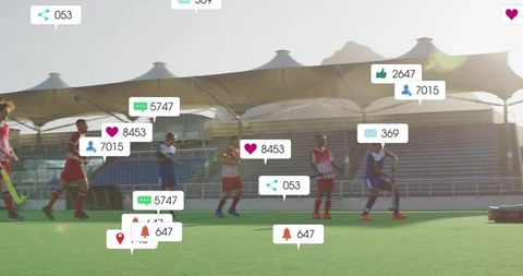 Youth field hockey players training with social media notification overlays at stadium