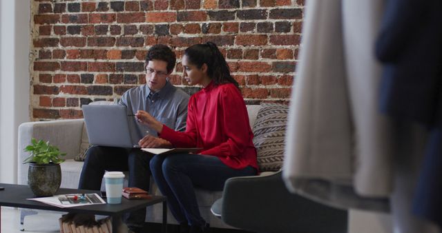 Two Young Professionals Collaborating on Laptop in Modern Office - Download Free Stock Images Pikwizard.com