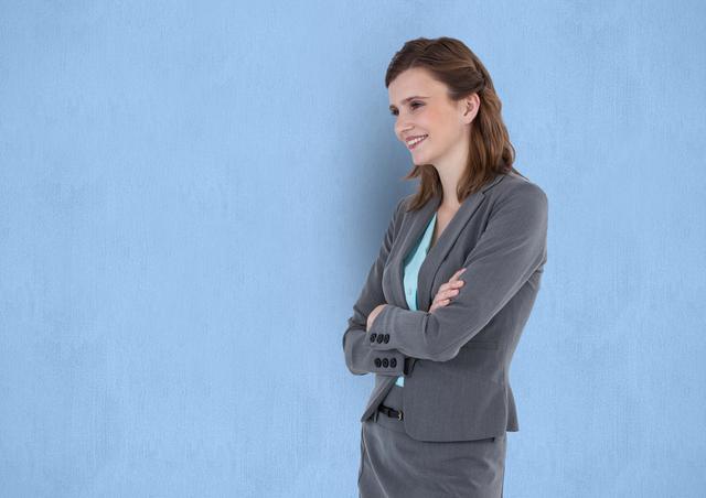 Digital composite of Smiling businesswoman with arms crossed against blue background
