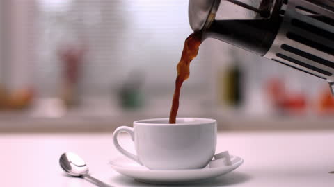Pouring Coffee from French Press into Cup in Kitchen