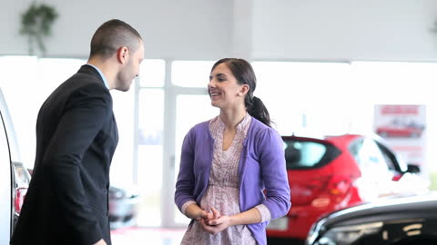 Car Salesman Engaging with Customer in Dealership