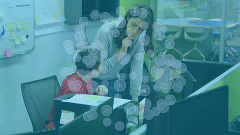 Coworkers Analyzing Data with Holographic Graphics Overlay