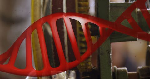 Red DNA Strand Overlay on Industrial Machine Background