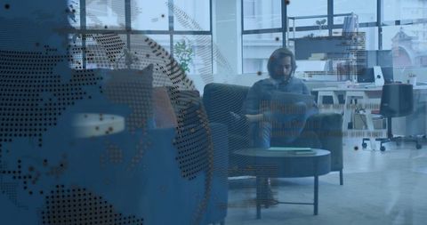 Remote worker using laptop in modern coworking lounge with digital globe and code overlay