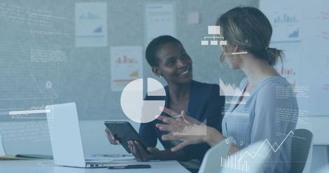 Two Businesswomen Discussing Data Analytics and Dashboard Insights While Collaborating