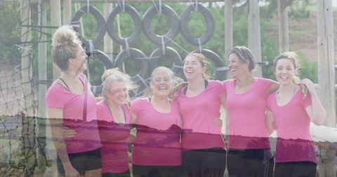 Group of Women Smiling at Outdoor Obstacle Course in Pink Activewear
