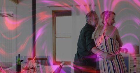 Romantic mature couple dancing embracing in kitchen