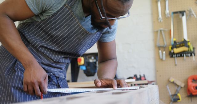 Focused Carpenter Measuring Wood Plank in Workshop - Download Free Stock Images Pikwizard.com