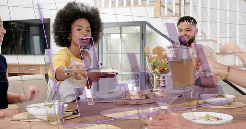 Friends sharing dinner, passing plate and pouring drink in modern home with ar overlay