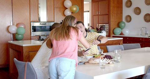 Friends enjoying brunch gathering in modern kitchen