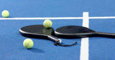 Padel Rackets and Balls on Blue Tennis Court