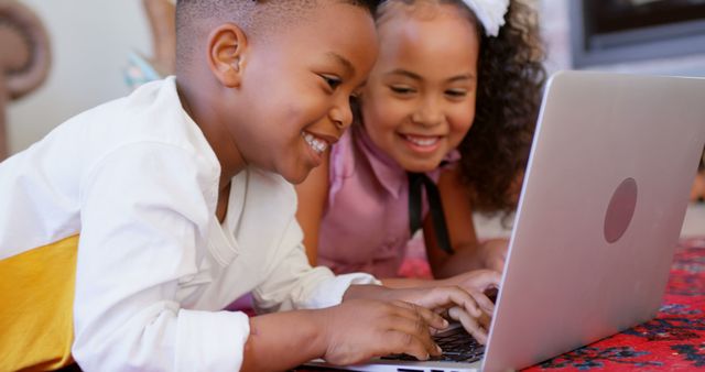 Happy Siblings Using Laptop, Smiling and Learning Together - Download Free Stock Images Pikwizard.com