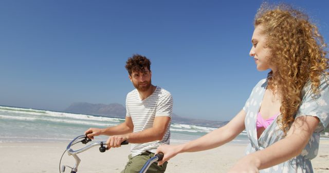 Young Couple Riding Bicycles on Beach Under Clear Sky - Download Free Stock Images Pikwizard.com