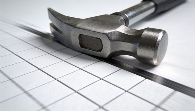 Closeup metal claw hammer head lying on tile grid with polished face and seam for diy repair