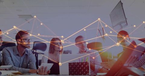 Business Team Collaborating Around Laptop Analyzing Data Visualization in Modern Office
