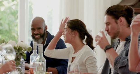 Friends Enjoying Wedding Reception With Wine and Lively Conversation