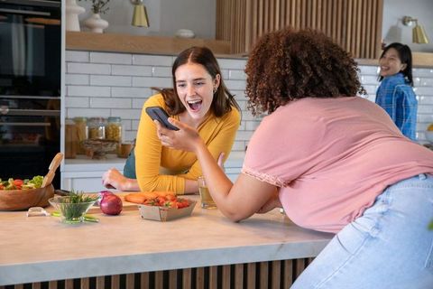 Friends Enjoying Shared Moments in Contemporary Kitchen