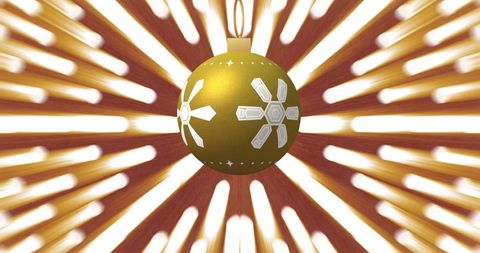 Golden Christmas Bauble with Elegant Snowflake Design and Radiant Light Trails