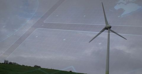 Rotating wind turbine on grassy hill under overcast sky with digital grid overlay