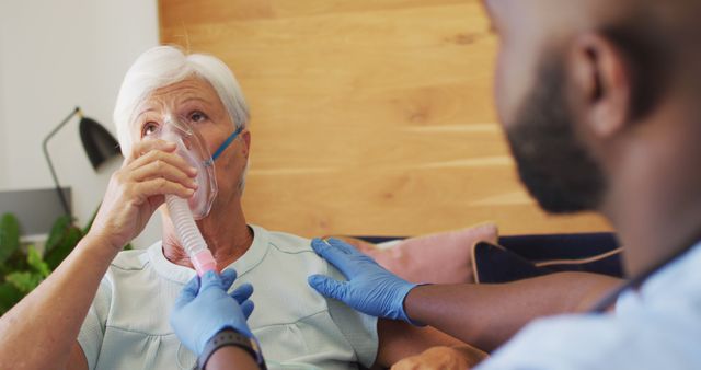 Image of african american male doctor keeping oxygen to caucasian senior woman - Download Free Stock Photos Pikwizard.com