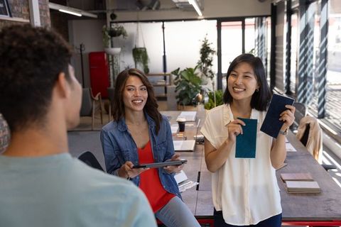 Diverse Coworkers Collaborating in Open-Plan Office with Color Samples