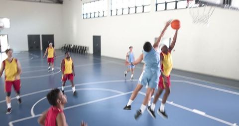 Intense Basketball Game Action with Players Contesting Shot