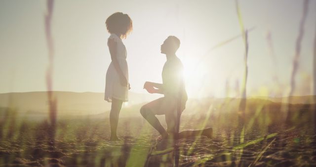 Image of happy african american couple at beach on sunny day over grass. marriage proposal, digitally generated image.