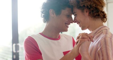 Joyful Romantic Moment Between Young Men Embracing at Home