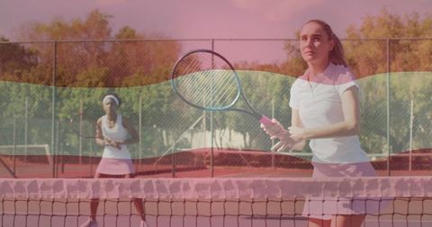 Female Tennis Players Intently Returning Ball on Vibrant Clay Court