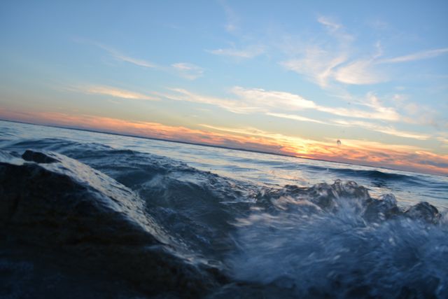 Close-up Waves Crashing Onto Rocks During a Stunning Sunset - Download Free Stock Photos Pikwizard.com