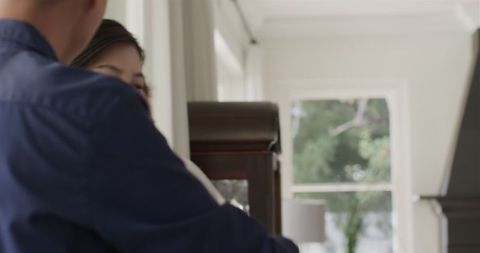 Couple discussing wedding plans at home in bright setting