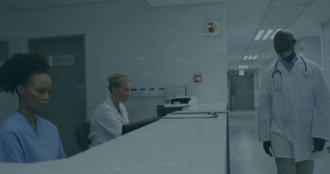 Medical staff collaborating at hospital reception desk