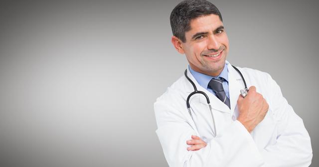 Doctor standing with arms crossed against grey background - Download Free Stock Photos Pikwizard.com